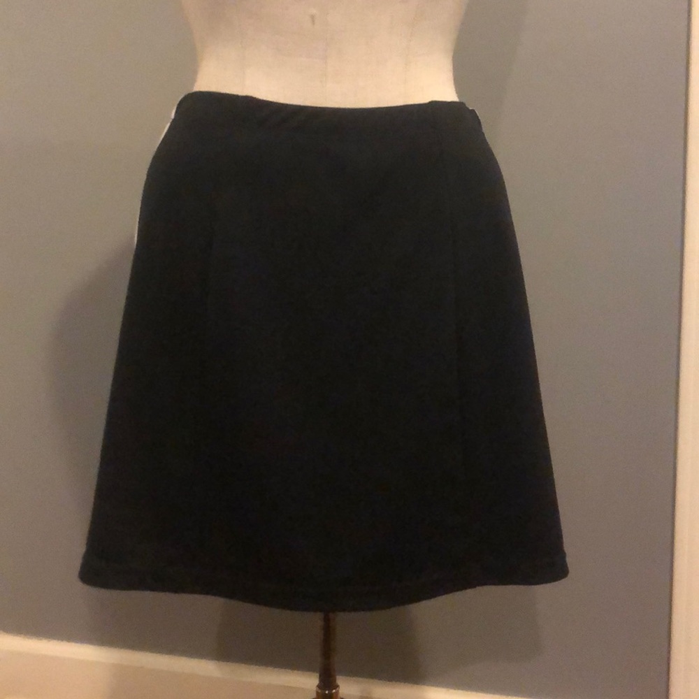 Black mini “tennis” skirt.